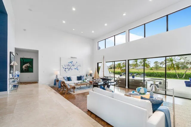 a living room with furniture and a floor to ceiling window