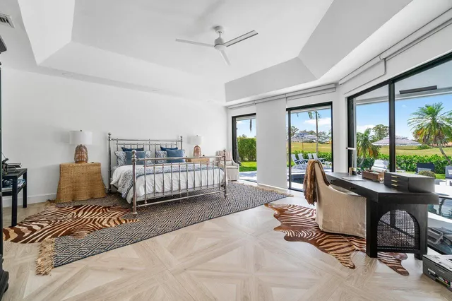 a spacious bedroom with a bed and a flat screen television