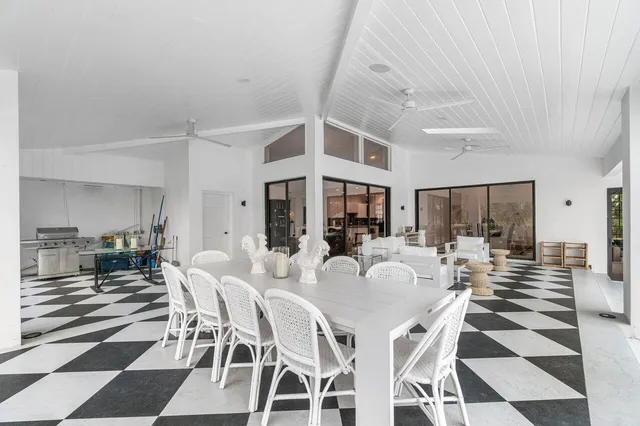 a view of a house with backyard porch and sitting area
