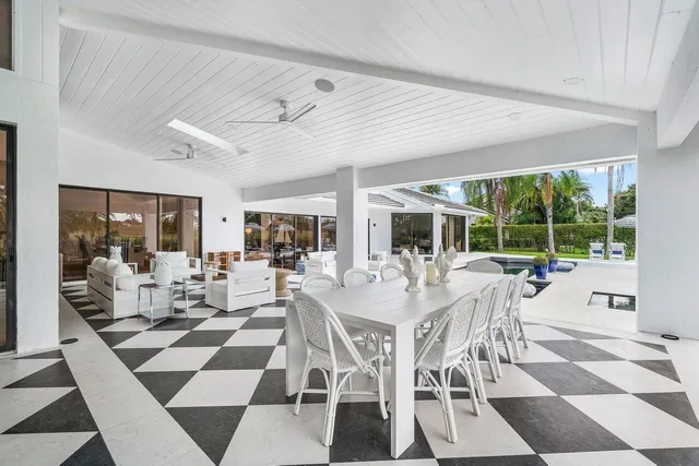 a view of a house with sitting area and a swimming pool