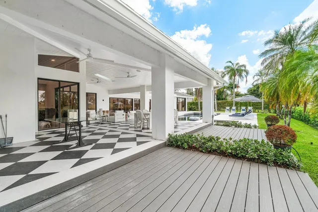 a view of a house with sitting area and swimming pool