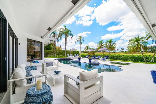 an aerial view of residential houses with outdoor space and swimming pool