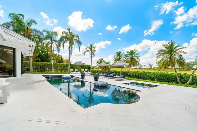 an aerial view of a house with a yard and garden