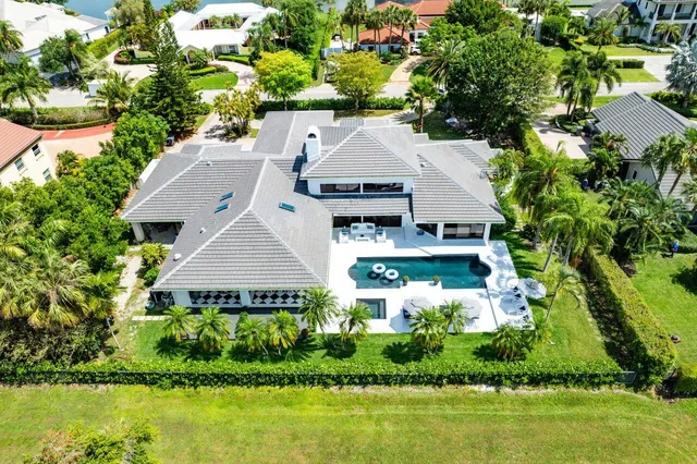 an aerial view of residential houses with outdoor space and swimming pool