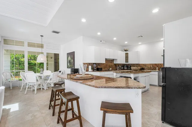 a large kitchen with a table and chairs
