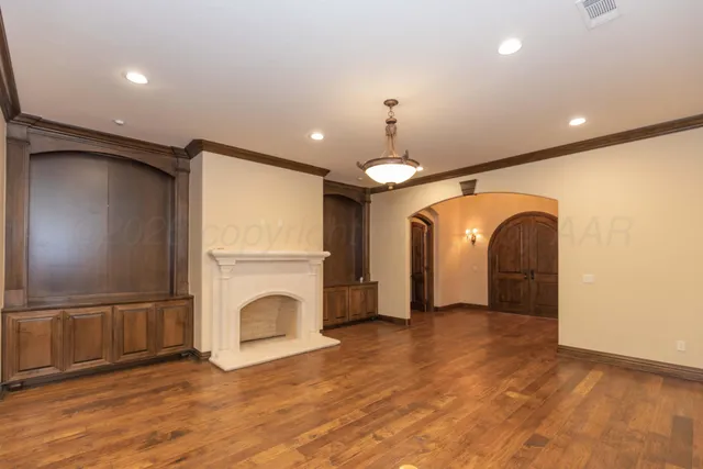 a large kitchen with kitchen island a large counter space a sink appliances and cabinets