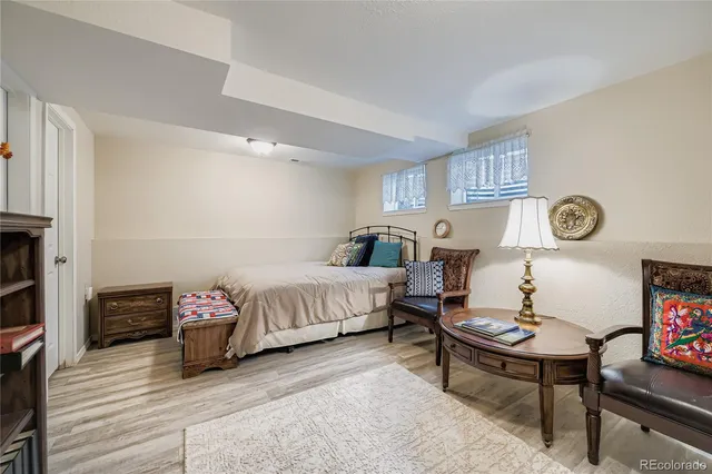 a spacious bedroom with a bed a couch and dresser