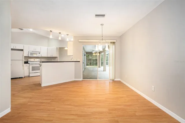 a view of a kitchen with wooden floor