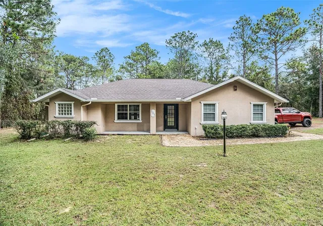 a front view of house with yard and green space