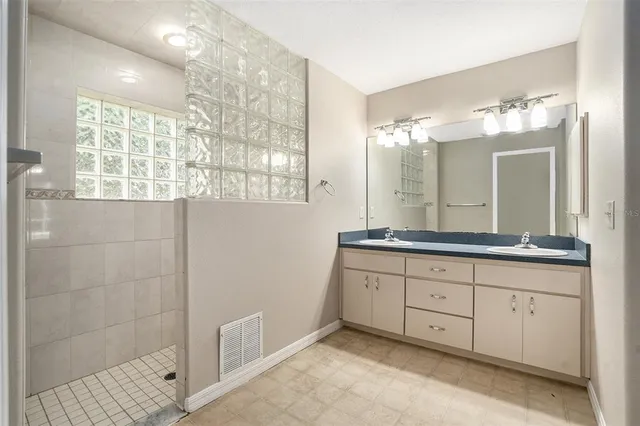 a bathroom with double sink and a mirror