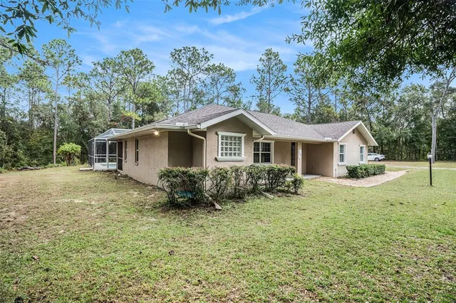 a view of house with backyard and garden