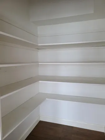 a view of storage and utility room with wooden floor