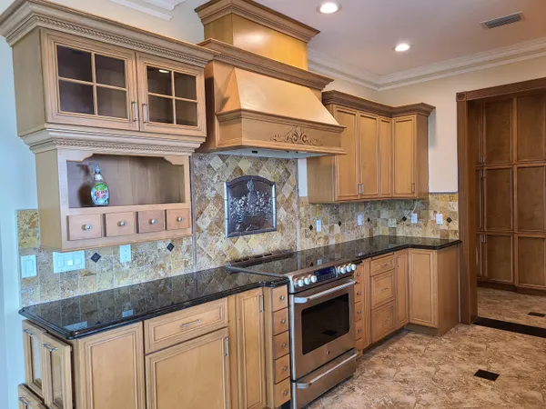 a kitchen with stainless steel appliances granite countertop a stove and a sink