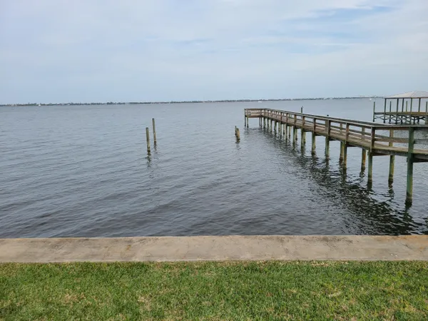 a view of a chairs and table on the wooden deck