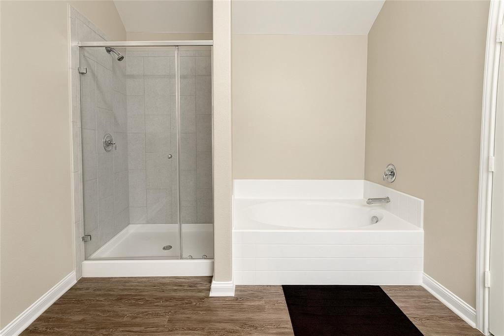 1837 Rialto Lane Crowley, TX 76036 - Photo 19 of 19 Spacious bathroom featuring a glass-enclosed shower with tile surround and a separate built-in soaking tub