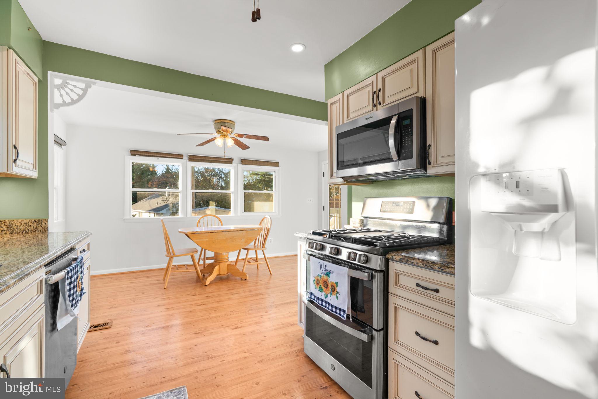 302 Regency Circle Linthicum Heights, MD 21090 - Photo 11 of 33 a kitchen with stainless steel appliances granite countertop a stove a sink and a microwave