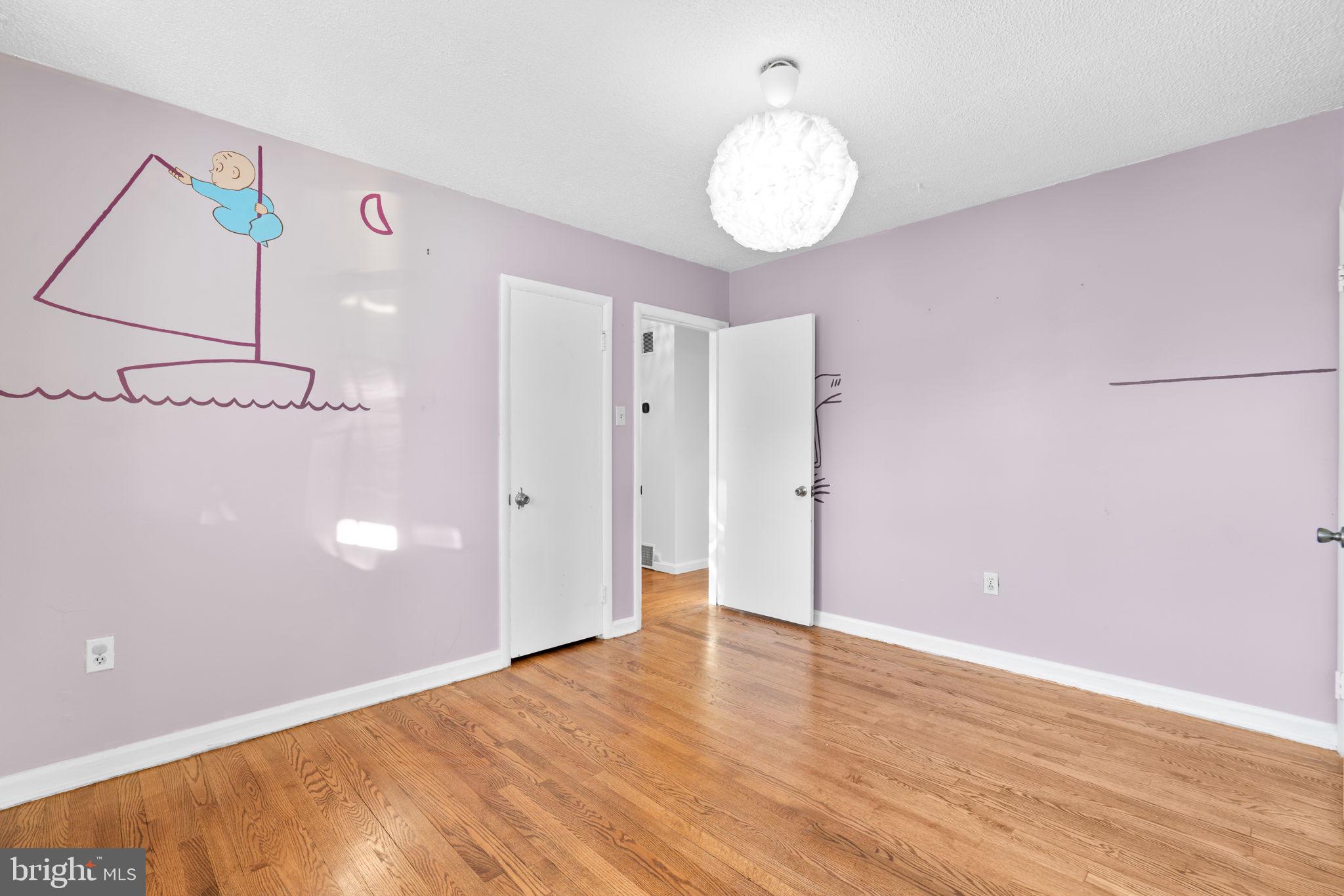 302 Regency Circle Linthicum Heights, MD 21090 - Photo 19 of 33 a view of an empty room with wooden floor and a large window