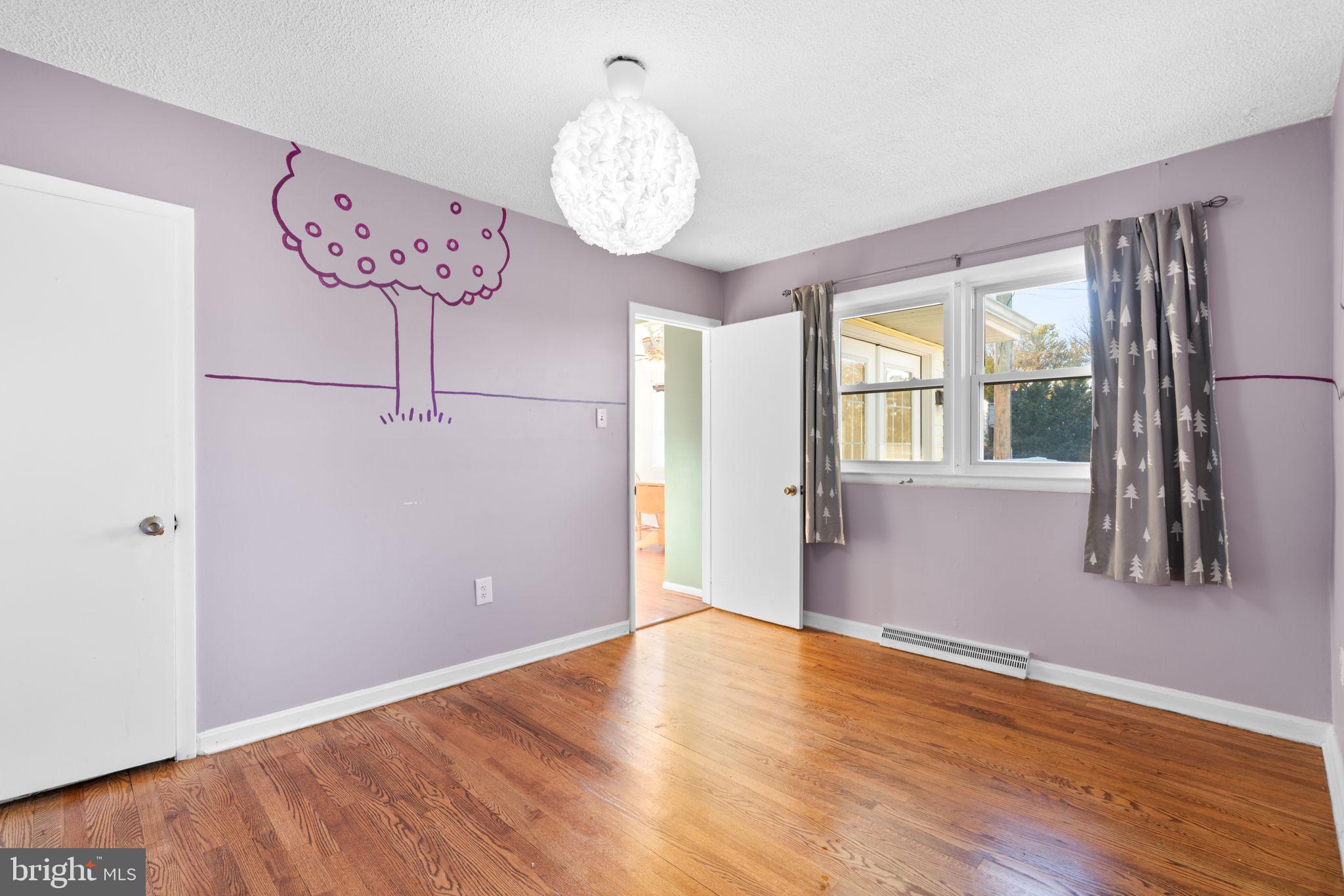 302 Regency Circle Linthicum Heights, MD 21090 - Photo 20 of 33 a view of an empty room with wooden floor and a large window