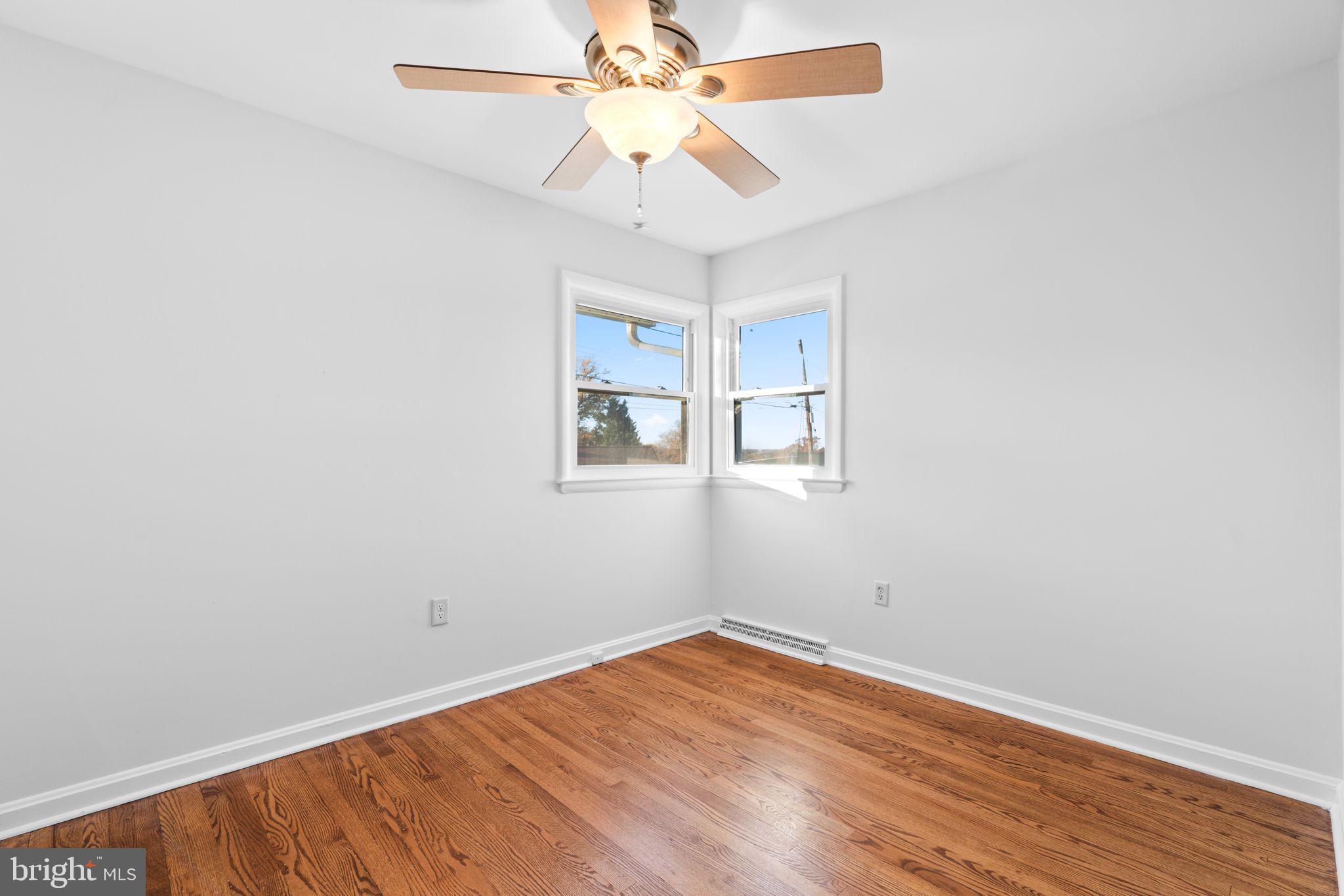 302 Regency Circle Linthicum Heights, MD 21090 - Photo 21 of 33 an empty room with a window and a ceiling fan