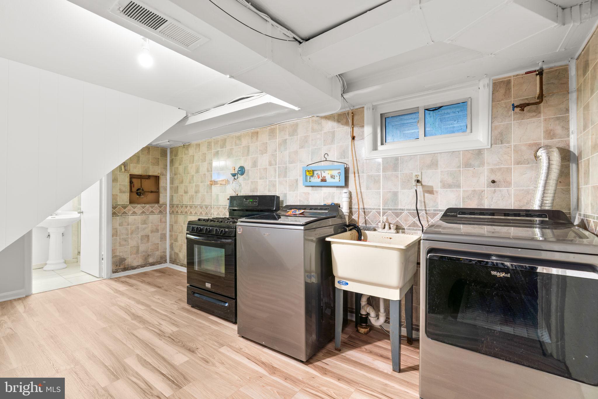 302 Regency Circle Linthicum Heights, MD 21090 - Photo 27 of 33 a kitchen with a stove sink and refrigerator