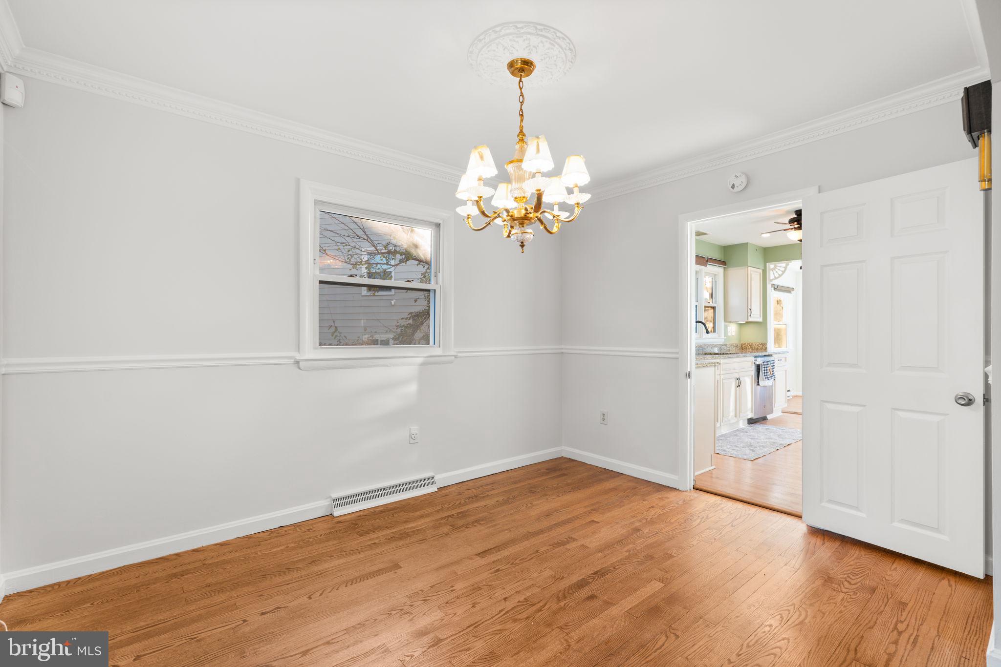 302 Regency Circle Linthicum Heights, MD 21090 - Photo 9 of 33 a view of a room with wooden floor and chandelier