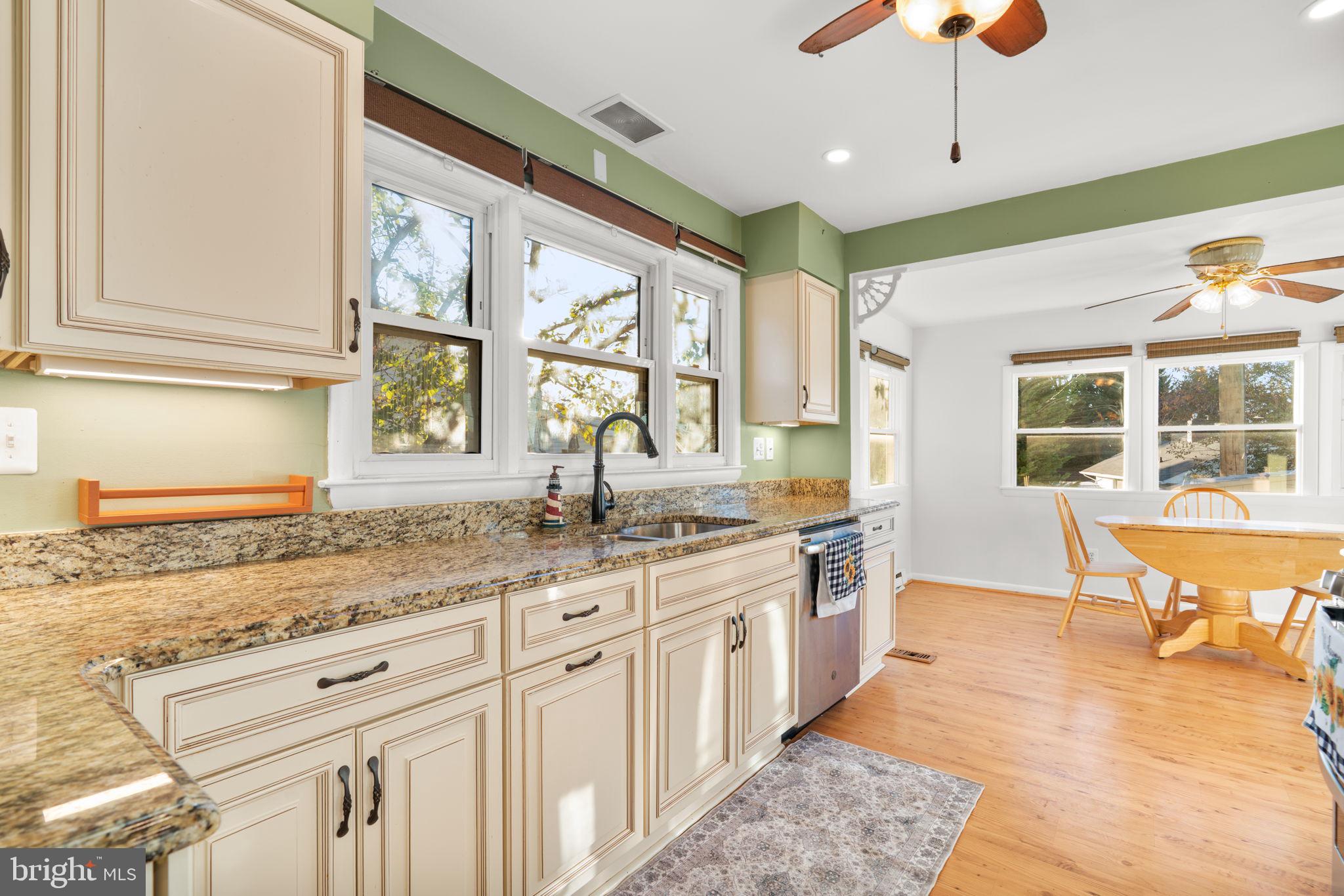 302 Regency Circle Linthicum Heights, MD 21090 - Photo 10 of 33 a large kitchen with kitchen island granite countertop a large window and stainless steel appliances
