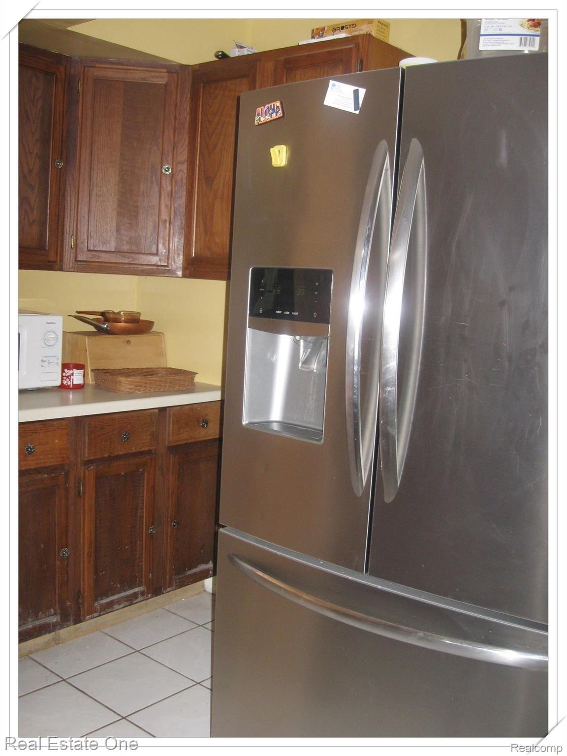 39875 Lotzford Road Canton, MI 48187 - Photo 19 of 41 Bump out area of kitchen has additional cabinets and refrigerator