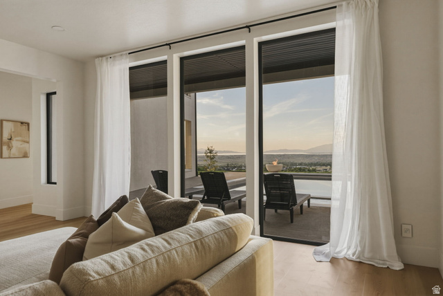 923 North Emery Lane Elk Ridge, UT 84651 - Photo 58 of 101 Expansive glass sliding doors with sheer drapery open to an outdoor patio with distant scenery