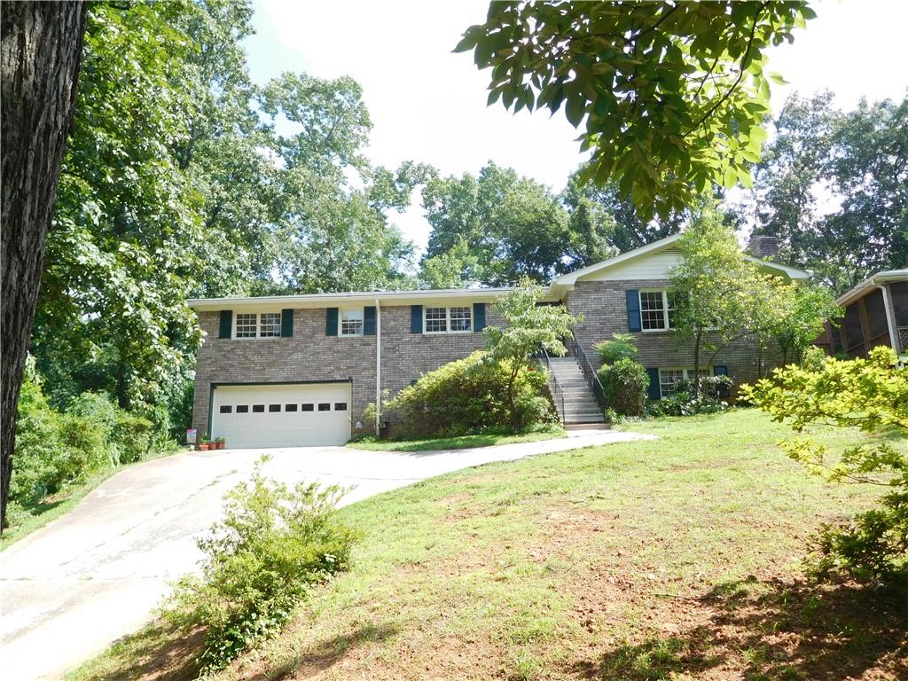 552 Duke Drive Marietta, GA 30066 - Photo 1 of 1 a front view of a house with a yard and garage