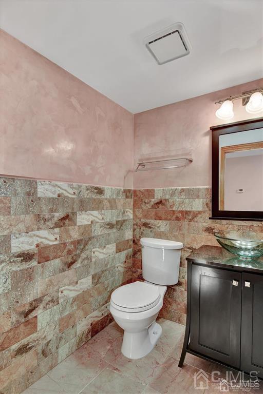 136 Redpine Loop Old Bridge, NJ 08857 - Photo 11 of 22 a bathroom with a toilet a sink and mirror