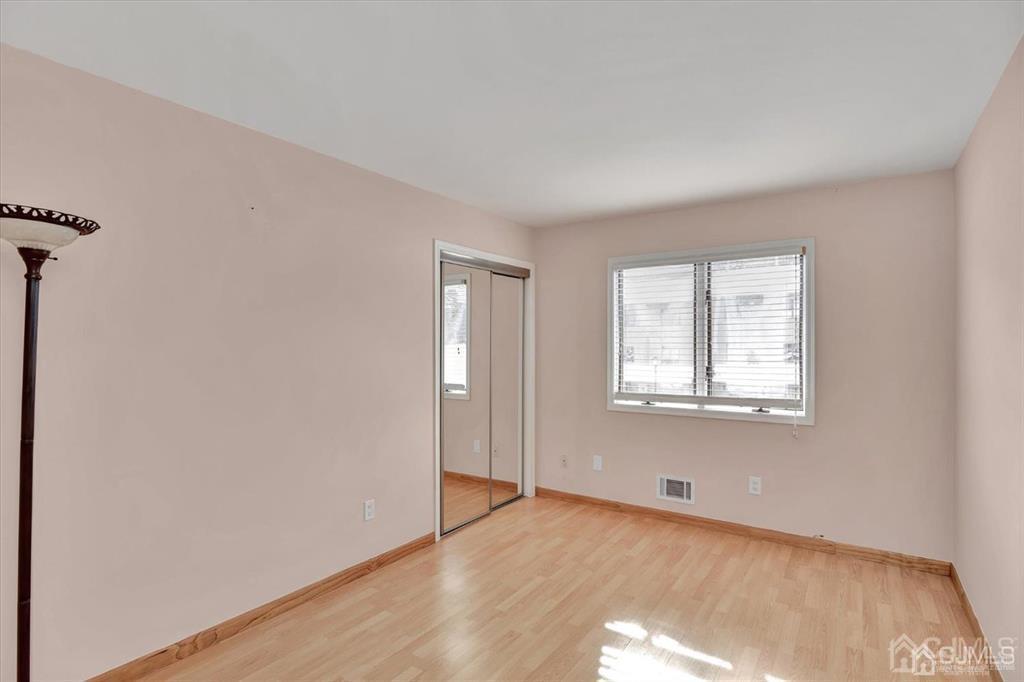 136 Redpine Loop Old Bridge, NJ 08857 - Photo 12 of 22 a view of an empty room with wooden floor and a window