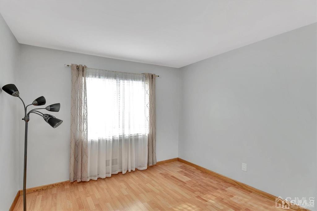 136 Redpine Loop Old Bridge, NJ 08857 - Photo 13 of 22 a view of a room with wooden floor and windows