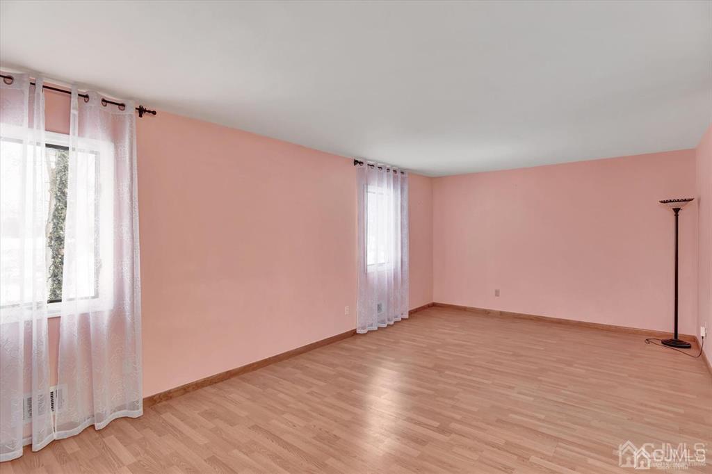 136 Redpine Loop Old Bridge, NJ 08857 - Photo 16 of 22 an empty room with wooden floor and windows