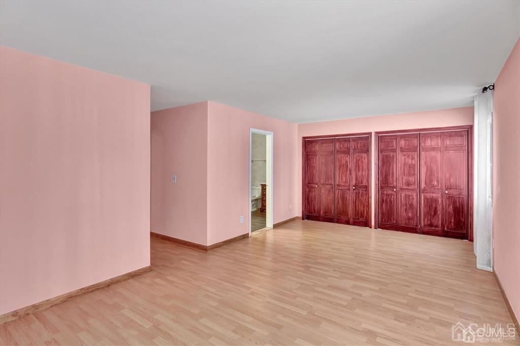 136 Redpine Loop Old Bridge, NJ 08857 - Photo 17 of 22 a view of an empty room with wooden floor