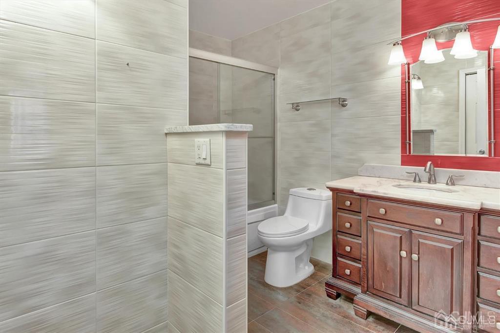 136 Redpine Loop Old Bridge, NJ 08857 - Photo 18 of 22 a bathroom with a granite countertop toilet a sink a mirror and shower