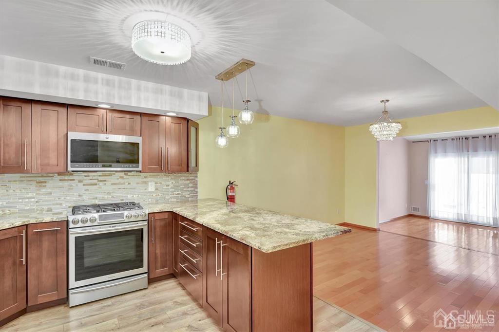 136 Redpine Loop Old Bridge, NJ 08857 - Photo 3 of 22 a kitchen with a stove and a microwave