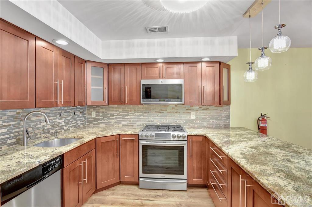 136 Redpine Loop Old Bridge, NJ 08857 - Photo 4 of 22 a kitchen with a sink stove and cabinets