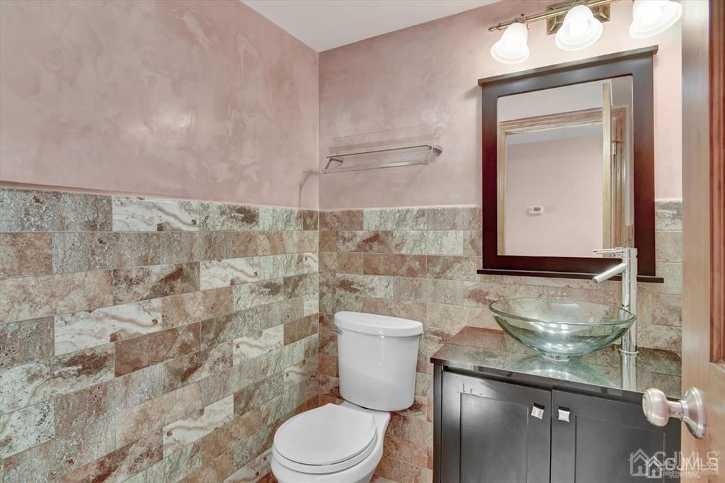 136 Redpine Loop Old Bridge, NJ 08857 - Photo 10 of 22 a bathroom with a toilet a sink and mirror