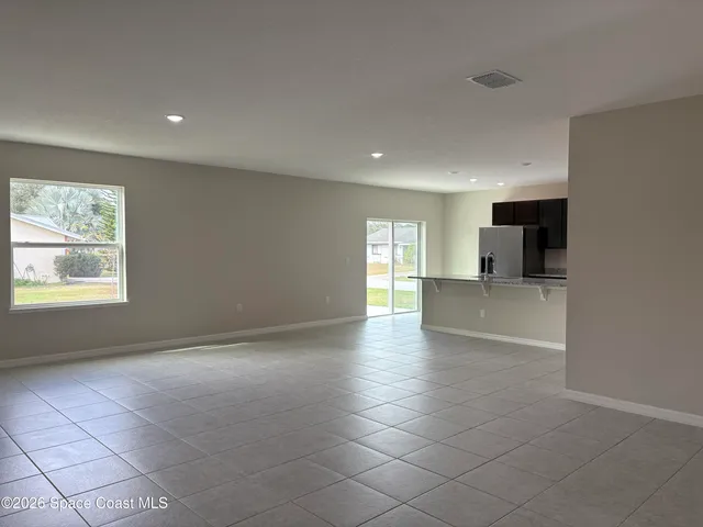 a kitchen with stainless steel appliances granite countertop a refrigerator and a microwave