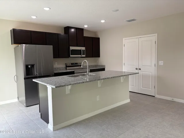 a view of an empty room and fire place
