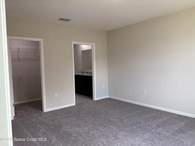 a bathroom with a granite countertop sink a toilet and a mirror