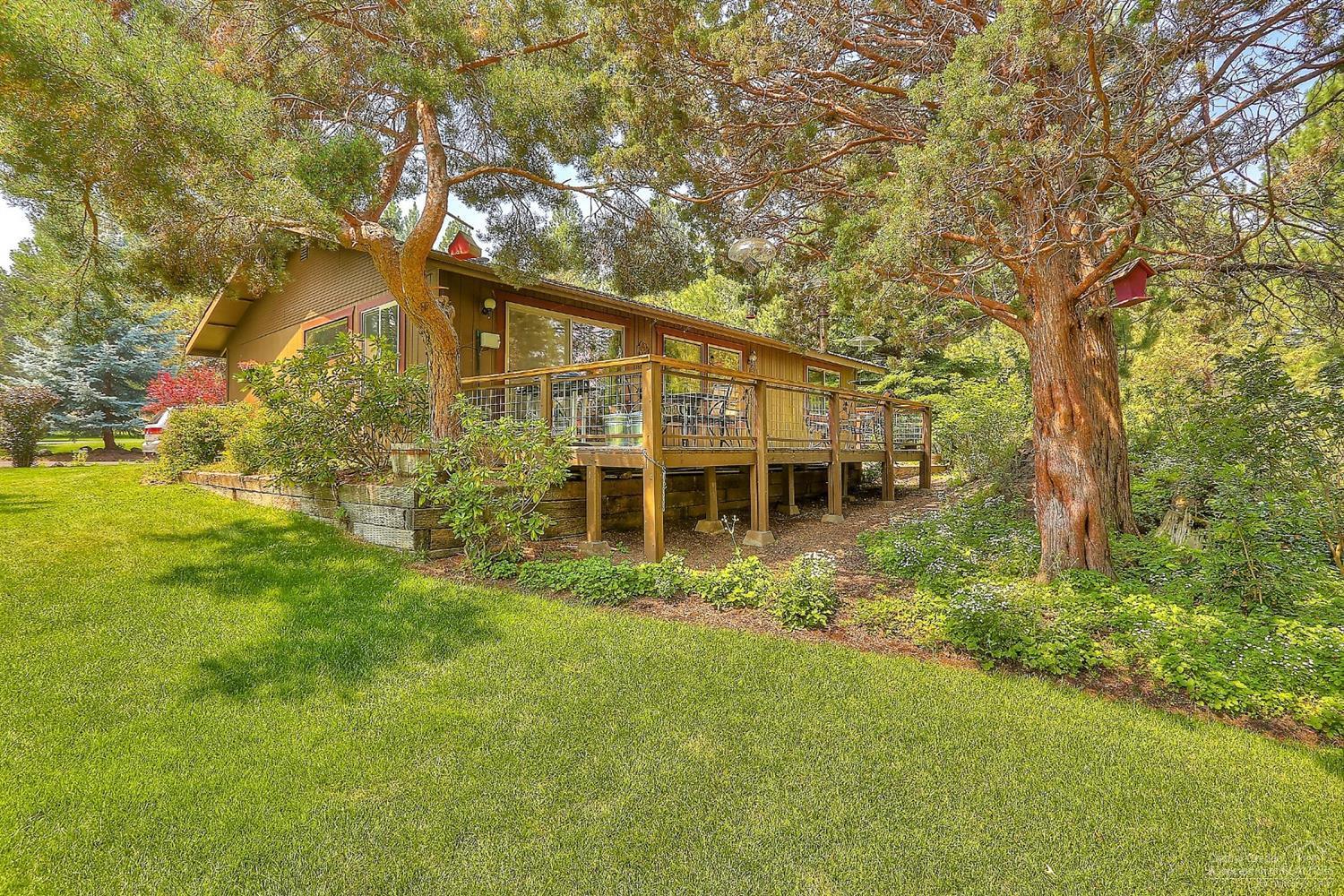 20358 Donkey Sled Road Bend, OR 97702 - Photo 1 of 17 a view of house in front of a big yard with large trees