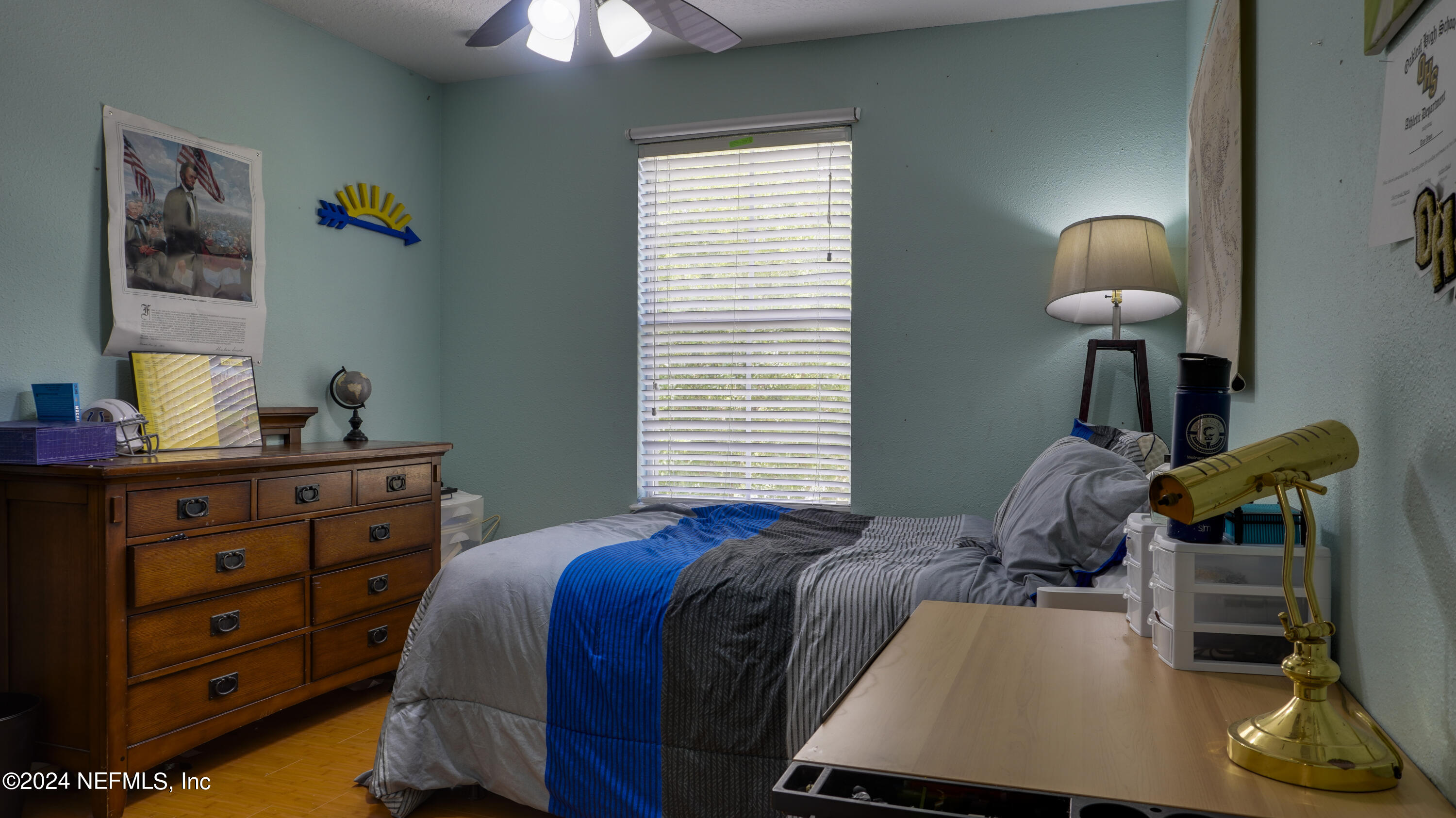 3838 Chasing Falls Road Orange Park, FL 32065 - Photo 16 of 33 a bedroom with a bed and a chandelier