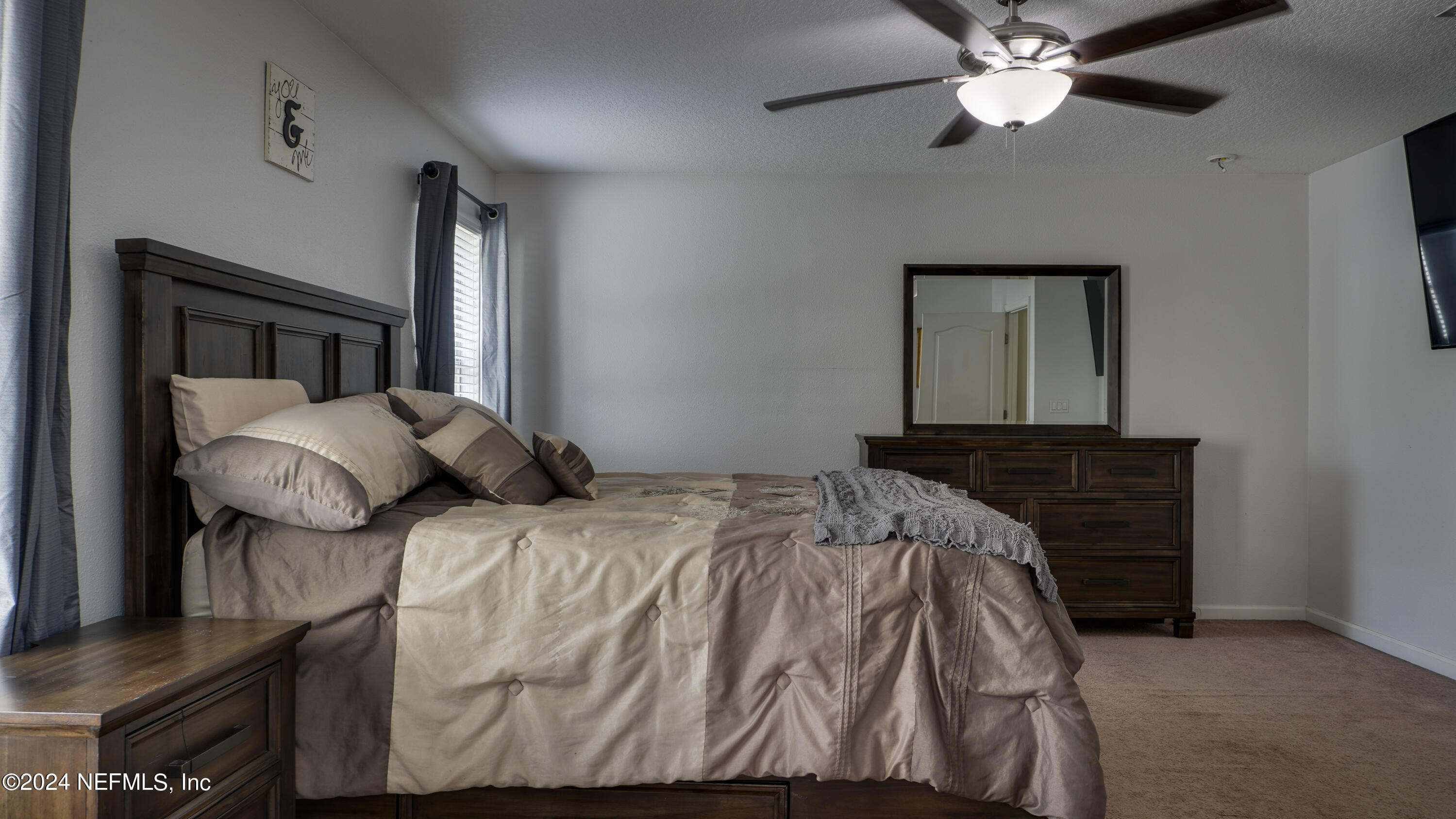 3838 Chasing Falls Road Orange Park, FL 32065 - Photo 25 of 33 a bedroom with a bed and a chandelier