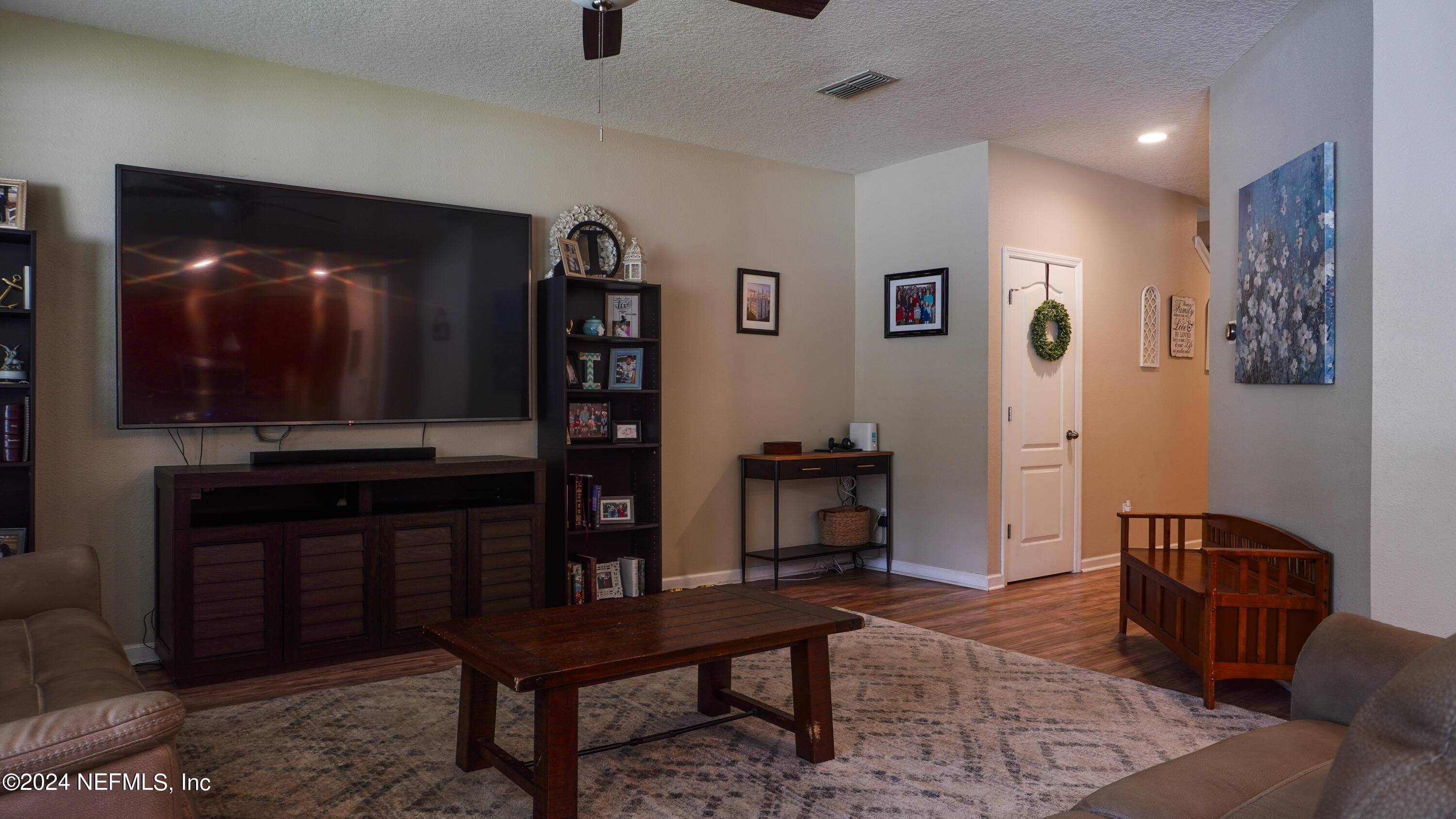 3838 Chasing Falls Road Orange Park, FL 32065 - Photo 3 of 33 a living room with furniture a piano and a bookshelf