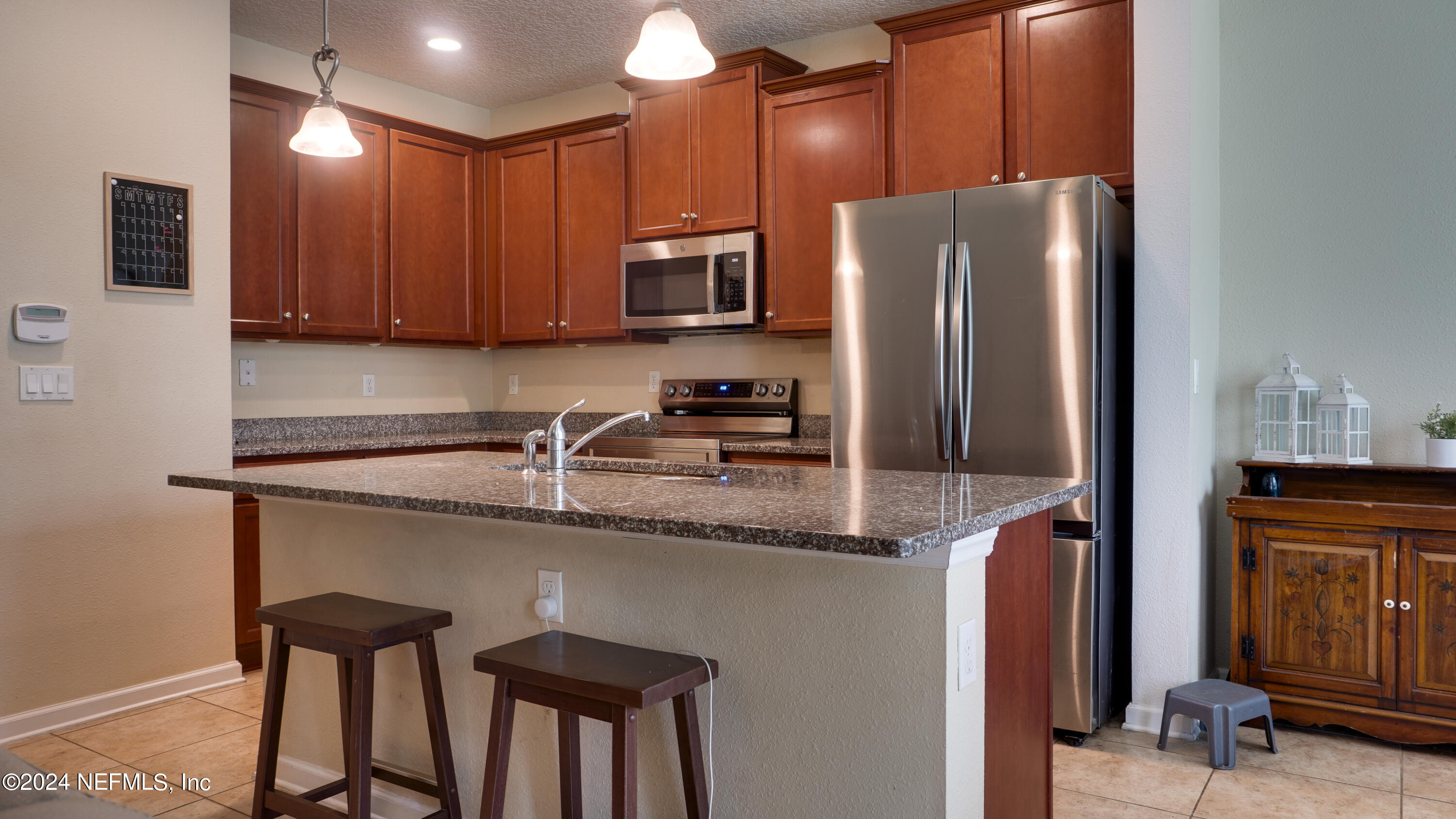 3838 Chasing Falls Road Orange Park, FL 32065 - Photo 7 of 33 a kitchen with stainless steel appliances granite countertop a refrigerator and a stove top oven