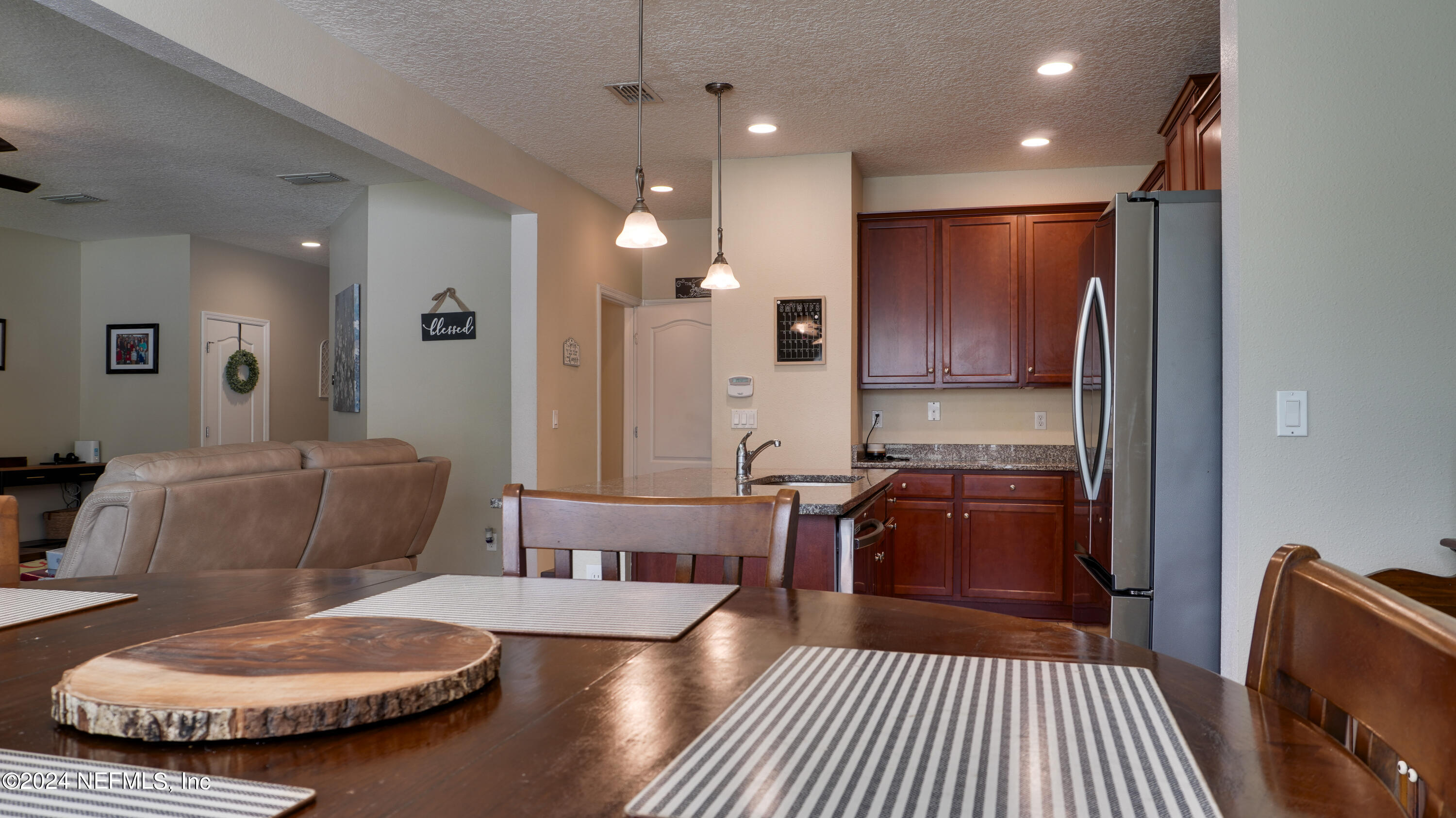 3838 Chasing Falls Road Orange Park, FL 32065 - Photo 9 of 33 a large kitchen with sink a refrigerator and a fireplace