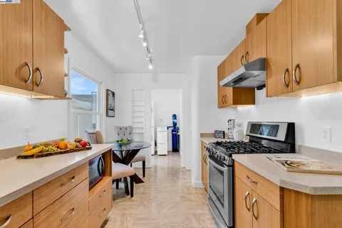 a kitchen with stainless steel appliances granite countertop a stove a refrigerator and a cabinets