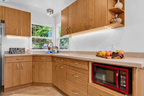 a kitchen with stainless steel appliances granite countertop a sink a stove and a refrigerator
