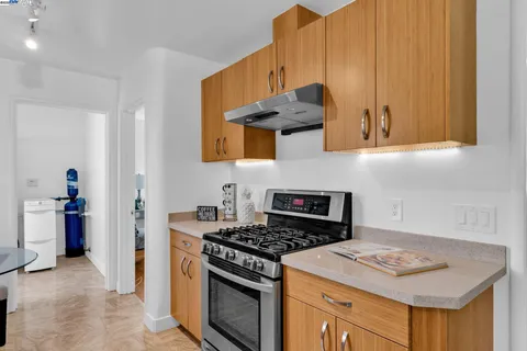a kitchen with stainless steel appliances kitchen island granite countertop a table and chairs in it